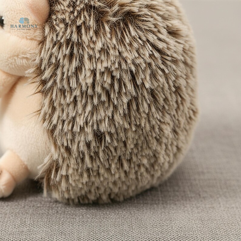 May include: A soft toy hedgehog, featuring a beige face and belly, and a back covered in brown and tan spiky fur. The plush toy is designed to be child-friendly and could be used as a decorative item.