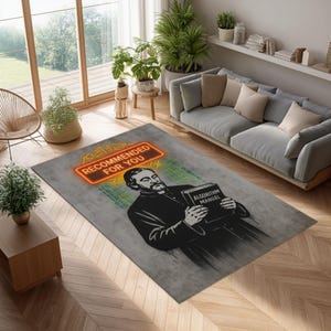 Puede incluir: Una alfombra rectangular con fondo gris presenta un gráfico de un hombre sosteniendo un libro titulado "Algorithm Manual". La alfombra tiene un letrero de neón que dice "Recommended for You" y código binario verde. La alfombra está en una sala de estar.