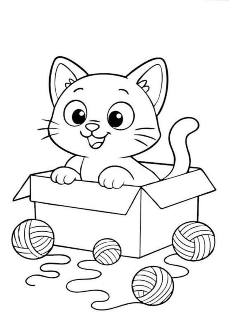 May include: A black and white cartoon illustration of a smiling cat inside a cardboard box. The cat is surrounded by three balls of yarn and loose yarn strands. The cat has large eyes and whiskers.