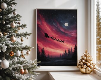May include: A framed Christmas art print depicts Santa Claus in his sleigh, pulled by reindeer, silhouetted against a vibrant red and purple sky with a full moon. A decorated Christmas tree and a gold-colored decorative tree are in the foreground.