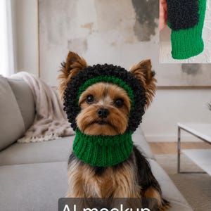 May include: A pet snood featuring a vibrant green ribbed neck section and a textured black curly yarn border around the face opening. The accessory is designed to fit around the head and neck, providing a snug fit with contrasting yarn textures.