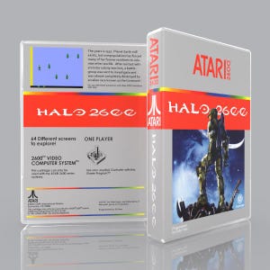 May include: A white Atari 2600 video game box for Halo 2600. The front features a soldier graphic, while the back displays game text, a screenshot, and a joystick icon. The design includes a horizontal rainbow stripe and the Atari logo in red.