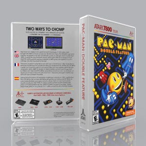 May include: A white Atari 7800 video game case for Pac-Man Double Feature. The front cover displays the yellow Pac-Man character, blue and red ghosts, and a maze. The back cover features game screenshots, text, and console compatibility icons.