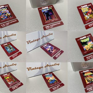 May include: A collection of Atari 2600 video game cartridges, each with a red background and game title. Titles include "32 in 1", "BMX Airmaster", "Bugs Bunny", "Crossbow", "Defender", "Desert Falcon", "Donkey Kong", "Fatal Run", and "Ikari Warriors".