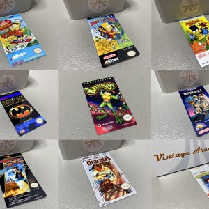 May include: A collection of colorful Nintendo game cartridges featuring various titles like "The Simpsons," "Batman," and "Beetlejuice." The cartridges are displayed near a white box with the text "Vintage Arcading."