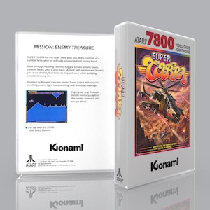 May include: A white Atari 7800 video game cartridge box for Super Cobra. The front features a combat helicopter illustration, the title Super Cobra, and the Konami logo. The back includes game mission text, a screenshot, and Atari branding.