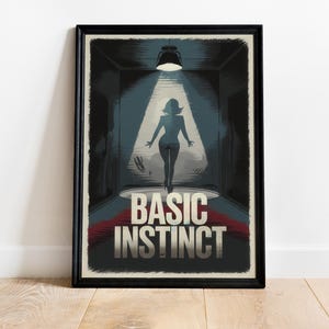 May include: Framed poster featuring a silhouette of a person in a spotlight, with the words "BASIC INSTINCT" in bold letters. The artwork has a dark, noir-style aesthetic with a black frame.
