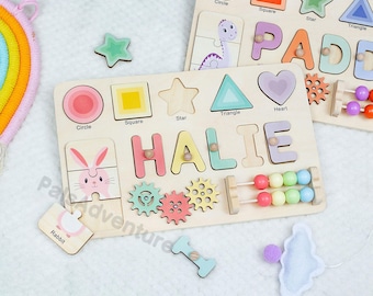 May include: Wooden educational toys featuring shape and letter puzzles, and an abacus. One puzzle spells "HALIE" and the other spells "PADE". The shapes include a circle, square, star, triangle, and heart. The toys are in various pastel colors.