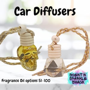 May include: Two car air fresheners with fragrance oil. One is a gold skull shape, the other is a geometric shape. Both have a wooden top and a gold and white rope for hanging. The text "Car Diffusers" and "Fragrance Oil options 51-100" are visible.