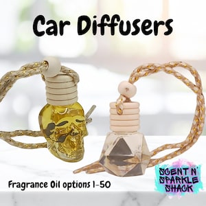 May include: Two car air fresheners with decorative bottles. One is a gold skull shape, the other is a geometric shape. Both have wooden tops and gold and cream colored cords. The text "Car Diffusers" and "Fragrance Oil options 1-50" are visible.