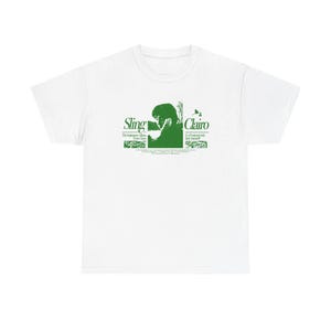 May include: A white short-sleeve t-shirt featuring a dark green graphic print on the chest. The design includes the text Sling and Clairo, a silhouette of a person, and additional small text detailing the album and production credits.