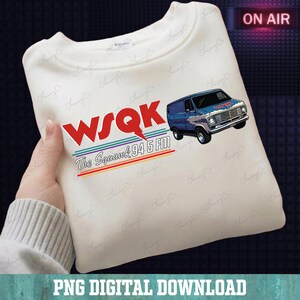 May include: Cream-colored sweatshirt featuring the text "WSQK The Squawk 94.5 FM" in red, with a blue van graphic. The sweatshirt has a crew neck and long sleeves. The words "ON AIR" are in a red box in the upper right corner.