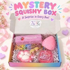 May include: A Mystery Squishy Box with the text 'MYSTERY SQUISHY BOX' and 'A Surprise in Every Box!' containing various squishy toys including a pink strawberry-shaped item, a cat paw, a glittery cube, and a peanut-shaped charm in plastic.