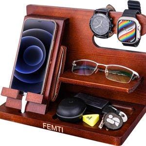 May include: A dark brown wooden desk organiser with a phone, wallet, glasses, watch, and keys. The organiser features a phone stand, watch holder, and a small shelf. The brand name "FEMTI" is printed on the front.