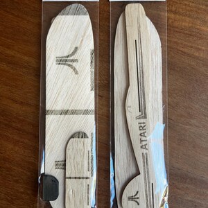 May include: Two wooden Sky Glider kits in clear plastic packaging. Each kit includes wooden airplane parts with the Atari logo and the text "Easy to Fly!" printed on the packaging.