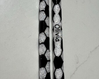 May include: Two pens with a soccer ball design. The pens are black and white with a glittery finish. One pen has the name "Olivia" written on it.