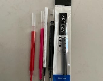 May include: A collection of five Arteza gel pen refills, including four loose refills with red, pink, white, and black ink, and one sealed package containing a blue ink refill labeled as a 0.7mm medium point gel pen refill.