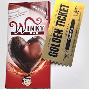 May include: A red and white "Winky Bar" chocolate bar with a heart-shaped chocolate center. A gold "Golden Ticket" lottery ticket is next to the chocolate bar. The ticket reads "You Win A Hand Job".