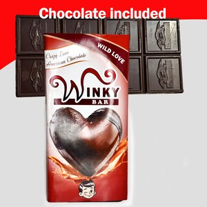 May include: A chocolate bar with a heart-shaped design, the packaging reads "Winky Bar" and "Crazy Love American Chocolate." The words "Chocolate included" are at the top. Several squares of dark chocolate are in the background.
