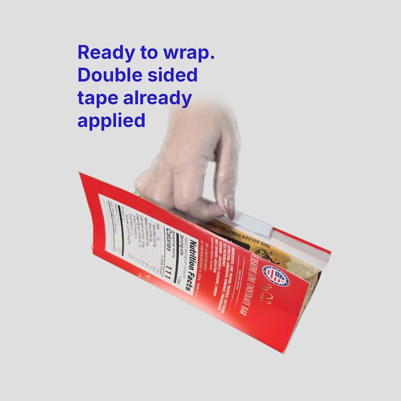 May include: A red and white chocolate bar box with the text "Ready to wrap. Double sided tape already applied." The box has a nutrition facts label and the words "CREATIVE LOVE CHOCOLATE BAR".