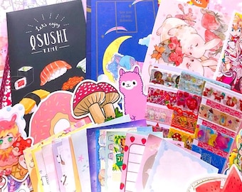 May include: A collection of stationery items, including stickers, notebooks, and decorative papers, in a pastel color palette. The items feature illustrations of sushi, mushrooms, cats, and anime-style characters. The text "Let's enjoy QSUSHI time" is visible on a black notebook.