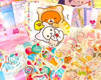 May include: A colorful assortment of stickers, stationery, and decorative items. The image features a variety of designs, including ice cream cones, cartoon characters, and floral patterns. A package of sticker flakes with the number 40 is visible.