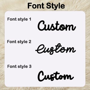 May include: A white background shows three different black "Custom" font styles. The text "Font Style" is at the top. Font style 1 is a bold, cursive font. Font style 2 is a more delicate cursive font. Font style 3 is a bold, cursive font.