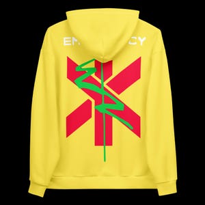 May include: Yellow hoodie with a red and green graphic design on the back. The design includes a red cross-like shape with a green, stylized lightning bolt. The word "EM...CY" is printed in white on the hood.