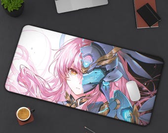 May include: A rectangular desk mouse pad featuring a split image of a female anime character. One side shows a face with pink hair and yellow eyes, the other a blue and gold robotic helmet. A white mouse sits on the pad.