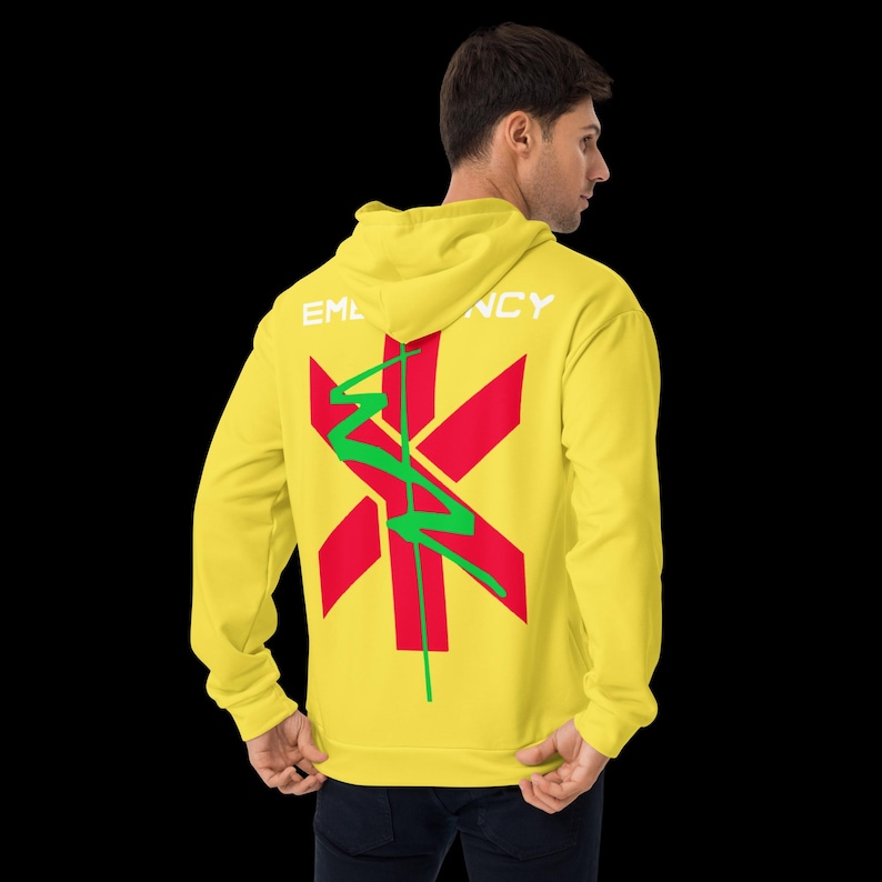 May include: A yellow hoodie with a red star of life graphic on the back, with a green squiggle design. The word "EMERGENCY" is printed in white across the top of the hoodie.