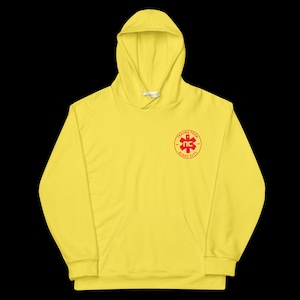 May include: A bright yellow hoodie with a front pocket and a drawstring hood. The hoodie features a red emblem on the chest with the text "TRAUMA TEAM" and "NC NIGHT CITY". The garment is made of a soft material.