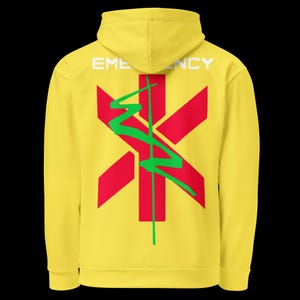 May include: Yellow hoodie with the word "EMERGENCY" in white across the top. A red star of life symbol is centered on the back, with a green lightning bolt design. The hoodie is a solid yellow color.
