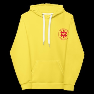 May include: Bright yellow hoodie with a front pocket and a drawstring hood. The hoodie features a red circular emblem on the upper left chest with the words "TRAUMA TEAM" and "NIGHT CITY" surrounding a red star symbol.