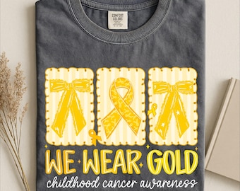 We Wear Gold T‑Shirt, Childhood Cancer Awareness Ribbon Apparel, Inspirational Outfit, Support Style for Awareness and Community Fashion