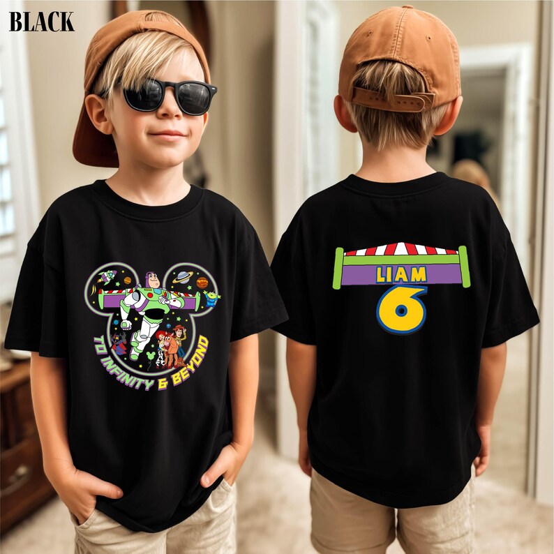 A young boy wearing a black t-shirt with a character from the Toy Story franchise, specifically Buzz Lightyear, and a name tag on the back.