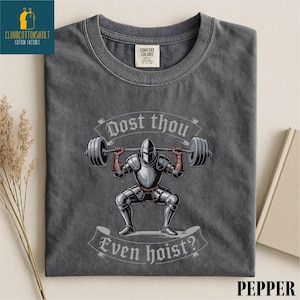 a gray t-shirt with a graphic design depicting a knight lifting a barbell, accompanied by the text "Do you even know?"