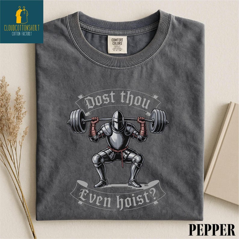 a gray t-shirt with a graphic design depicting a knight lifting a barbell, accompanied by the text "Do you even know?"
