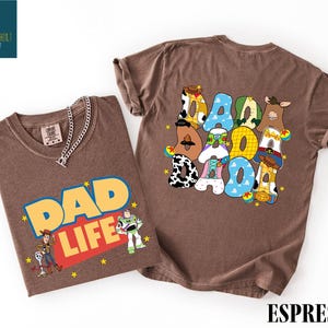 a brown t-shirt with a colorful graphic design and text, along with a smaller t-shirt with a similar design.