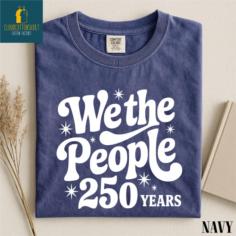 A navy blue t-shirt with white text that says "We the People 250 years" printed on it.