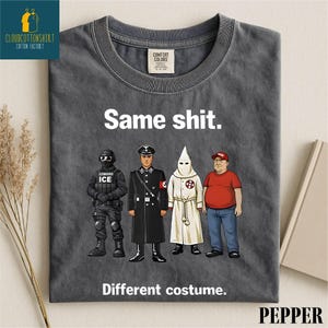 May include: Dark gray t-shirt with the text "Same shit." above a graphic of four figures in different uniforms and costumes. Below the graphic, the text reads "Different costume."
