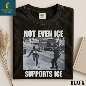 May include: Black t-shirt with the text "NOT EVEN ICE SUPPORTS ICE" in white block letters. The graphic is a black and white photo of a person running on a snowy street. The shirt has a Comfort Colors tag.