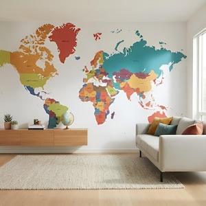 May include: A large, colorful world map wall decal featuring distinct shades of red, teal, yellow, and green for different continents. The map is applied to a white wall above a long, light-toned wooden floating console and a light-colored sofa.