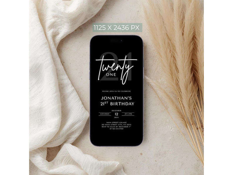 May include: A black smartphone displays a digital invitation for Jonathan's 21st birthday. The invitation features the words "Twenty One" in a stylish font, along with event details. The phone is set against a neutral background.