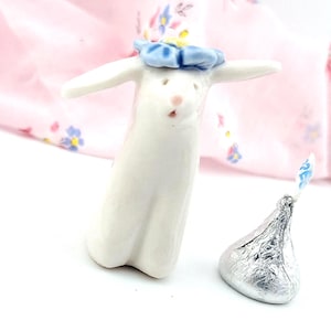 May include: A set of three ceramic mugs with a speckled, matte finish. The mugs are in shades of cream, light gray, and dark gray. Each mug has a simple, modern design and a rounded handle. Perfect for coffee or tea.