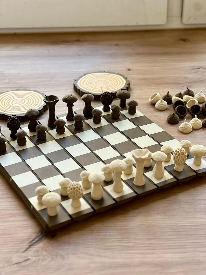 May include: A unique chess set featuring mushroom-shaped pieces in shades of brown and cream. The board is black and white, with two wooden coasters in the background. The chess pieces are intricately designed, adding a whimsical touch to the classic game.