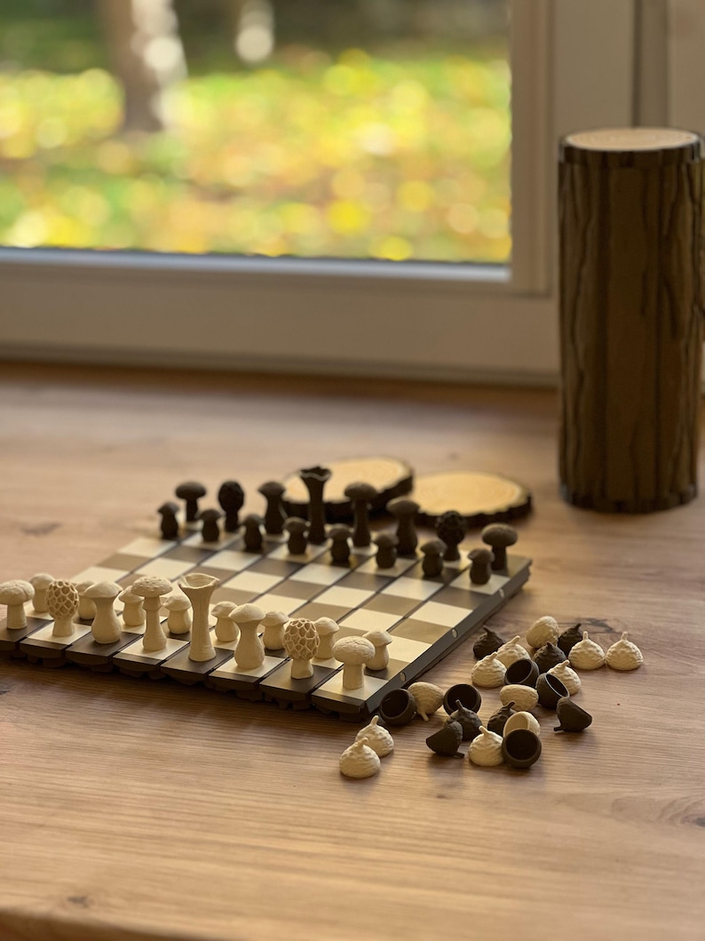 May include: A white ceramic mug with a black handle and the text "But First, Coffee" in a black, bold font. The mug is sitting on a wooden surface. The mug is approximately 4 inches tall.