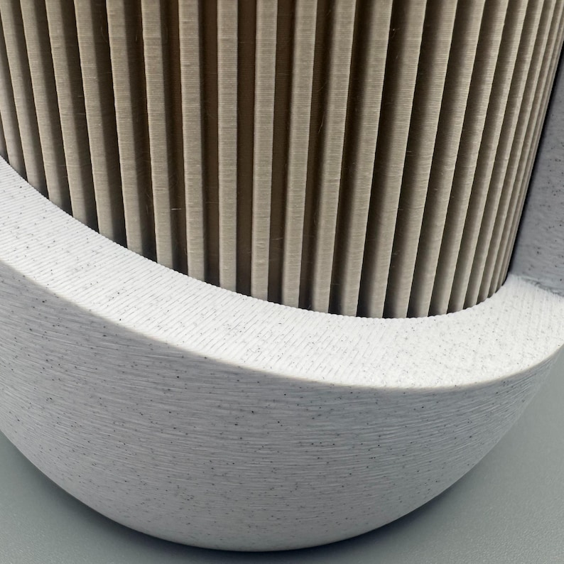 Alt text:
Close up of ribbed Japandi planter texture showing modern 3D printed design and integrated drip tray base.