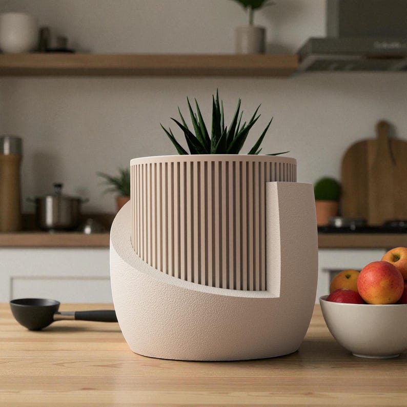 May include: A cylindrical planter with a vertical slat design in a light beige color, featuring a smooth, curved outer shell that partially wraps around the base. A dark green succulent plant is potted inside the center of the planter.