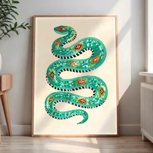 May include: A framed wall art print featuring a teal snake with a winding body, white spots, and black and white striped underbelly markings. The snake is decorated with orange and white diamond-shaped patterns against a cream background.