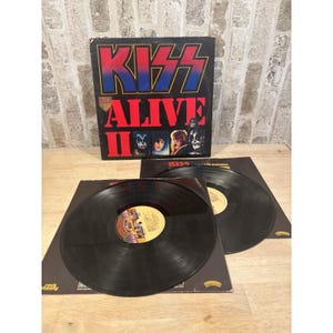 May include: A set of three ceramic mugs with a speckled, matte finish. The mugs are in shades of cream, light gray, and dark gray. Each mug has a simple, minimalist design and a rounded handle.